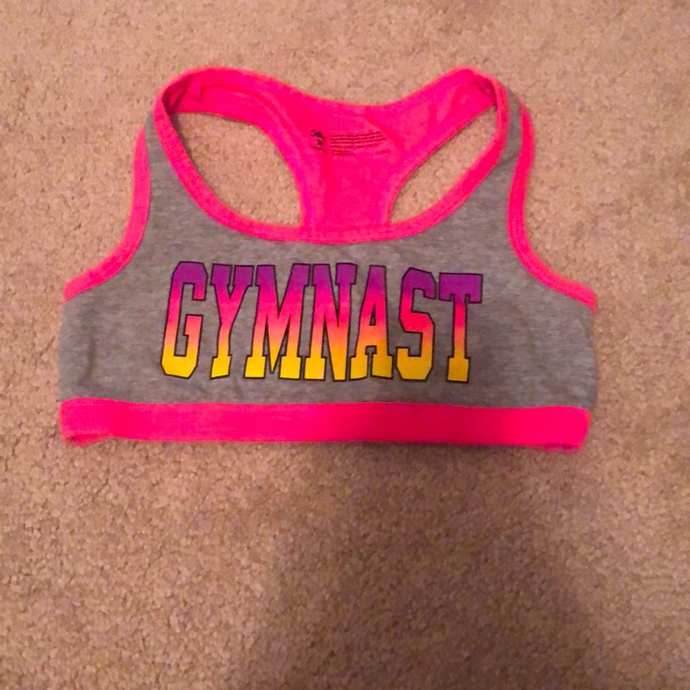 A justice sports bra with gymnastics written on it